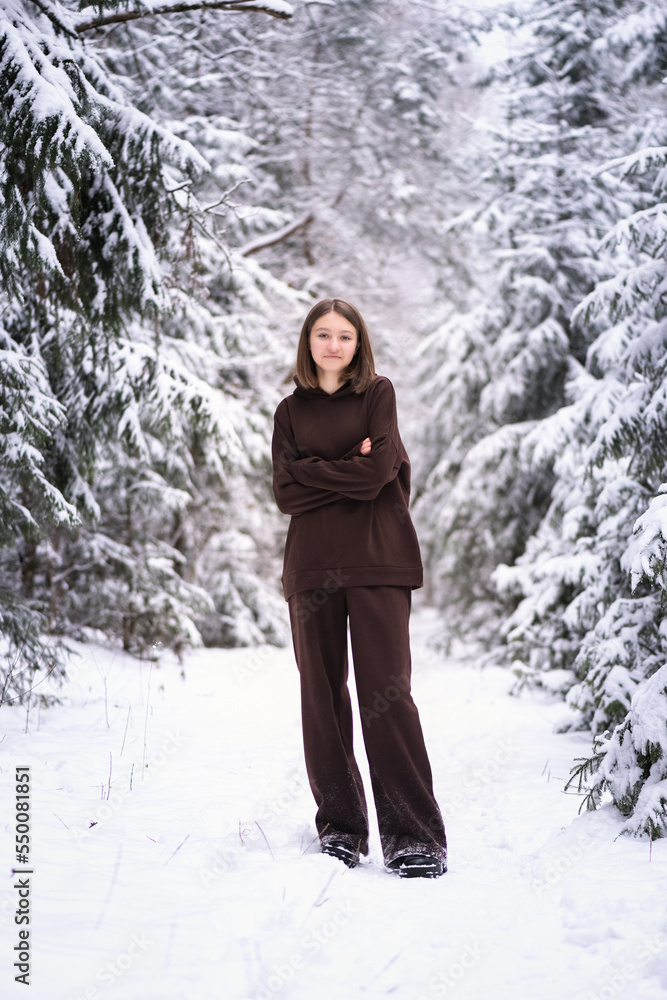 Portrait of a young beautiful fair-haired girl in a winter snowy forest. Portrait of a young beautiful fair-haired girl in a winter snowy forest.