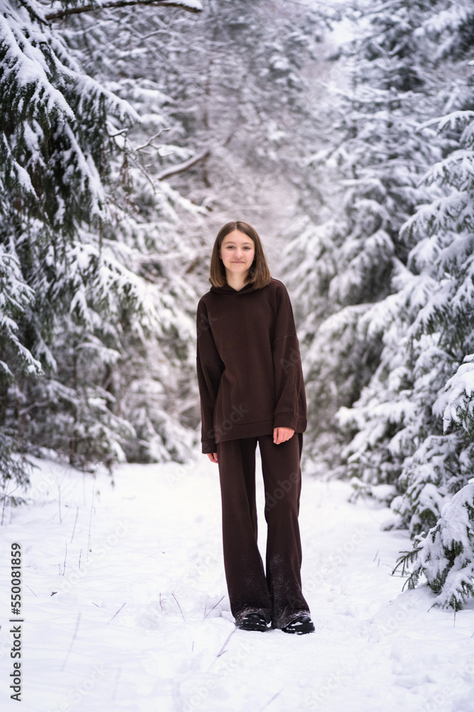 Portrait of a young beautiful fair-haired girl in a winter snowy forest. Portrait of a young beautiful fair-haired girl in a winter snowy forest.