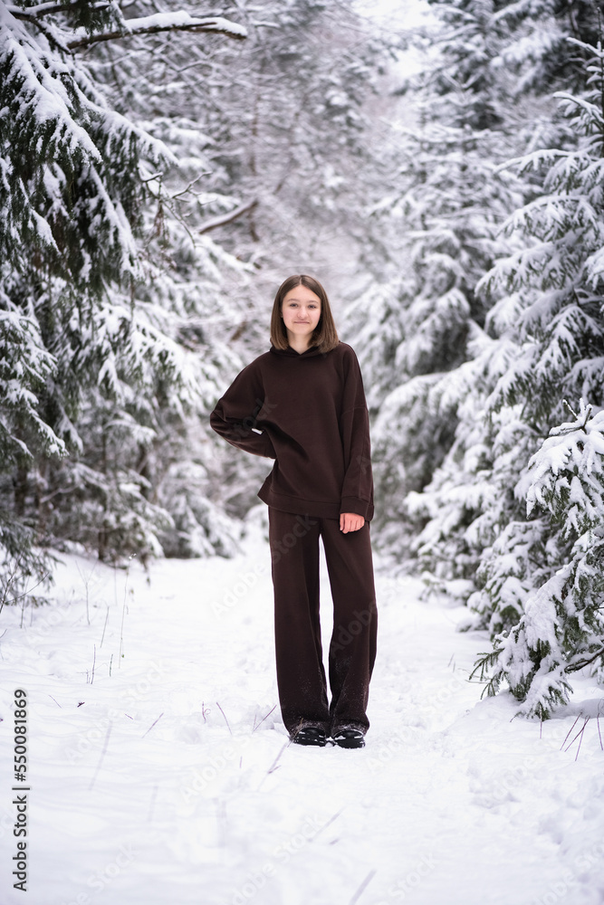 Portrait of a young beautiful fair-haired girl in a winter snowy forest. Portrait of a young beautiful fair-haired girl in a winter snowy forest.
