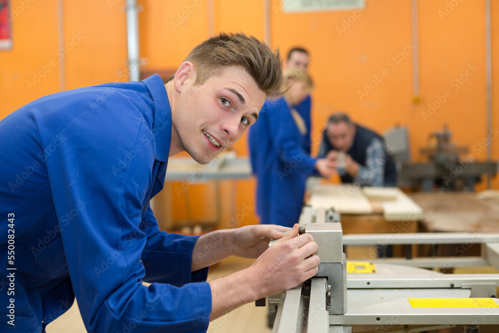 young mechanic apprentices in workshop
