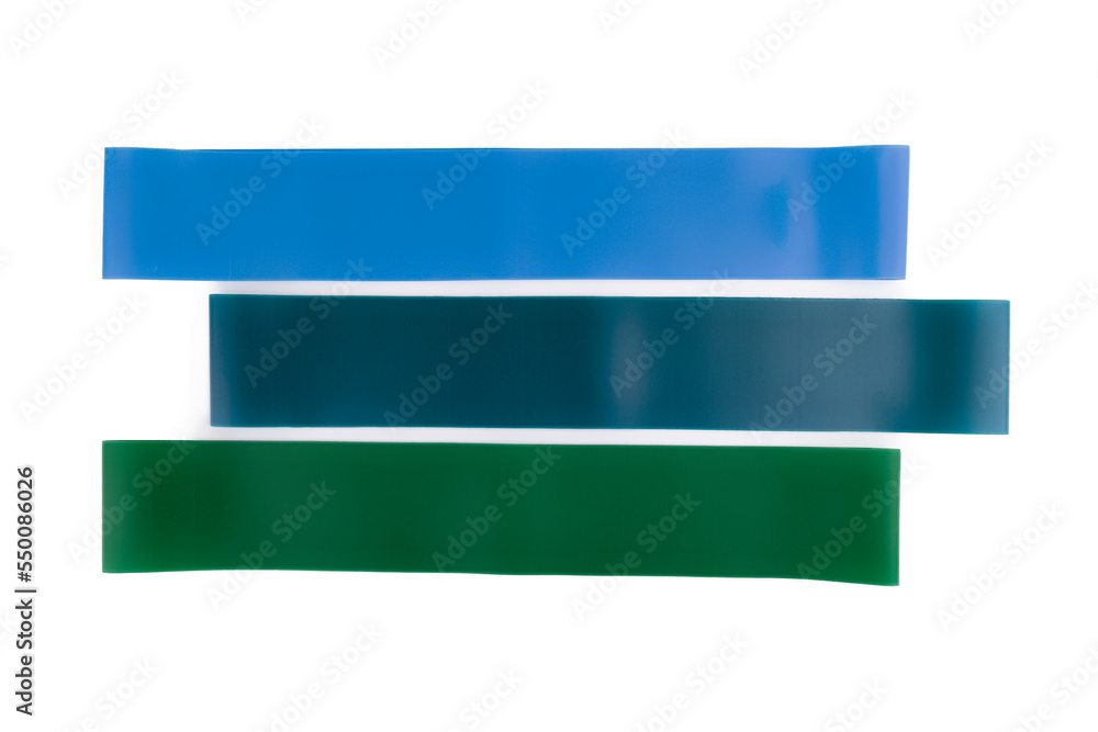 fitness elastic band. Woman showing a blue rubber band. Sport and healthy active lifestyle concept. A set of colorful elastic fitness band. fitness elastic band. Woman showing a blue rubber band. Sport and healthy active lifestyle concept. A set of colorful elastic fitness band.