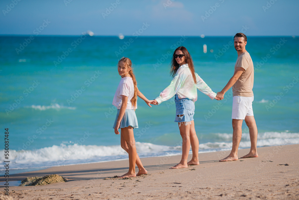 Happy family on the beach during summer vacation