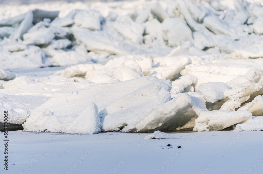 The bank of the Danube river covered with snow. Frozen, snow-covered banks of the Danube River below the Petrovaradin Fortress, Vojvodina, Novi Sad, Petrovaradin, Serbia.