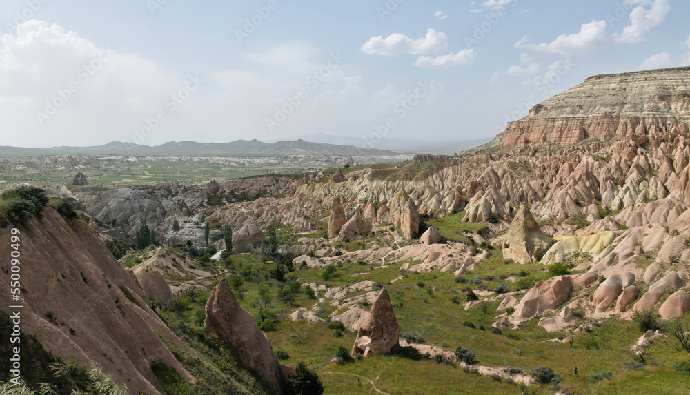 View of surreal rock formations at the Red Valley in Goreme National Park, Cappadocia, Turkey