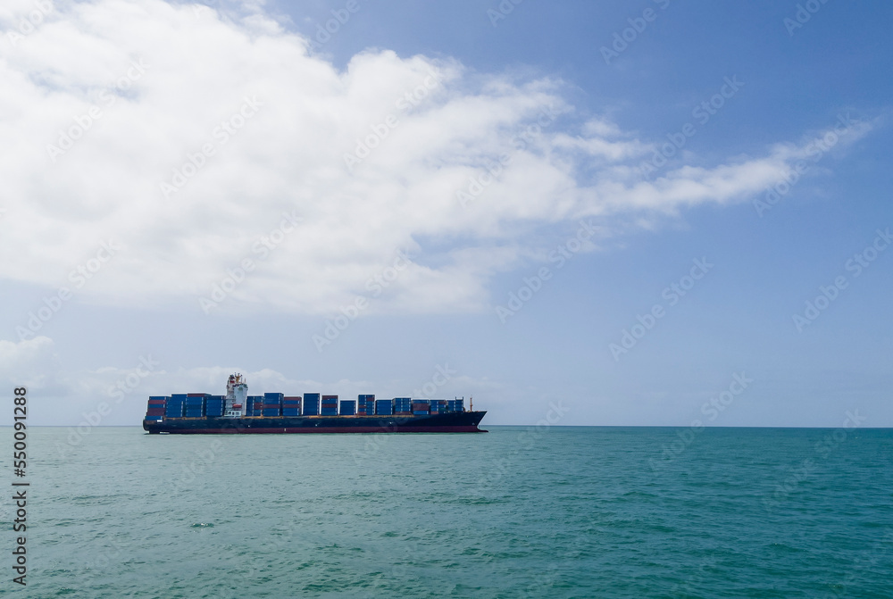 Container ship or container ship loaded with containers freight on the Indian ocean waves near the Zanzibar seaport. Container maritime shipping and transcontinental business concept photo.