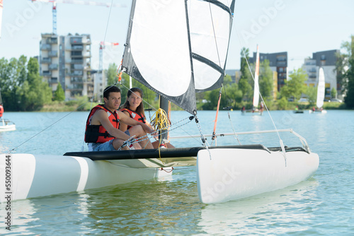 young couple sailing in a sunny day