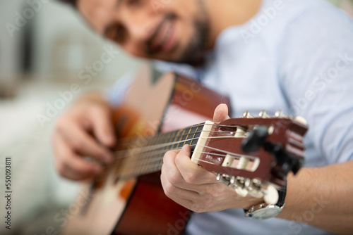 man playing guitar close-up shot