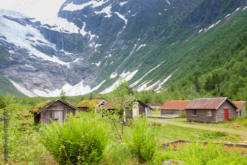 Fjaerland, Norway - June 10 2022: view at Jostedal Glacier with traditional Norway houses