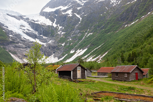 Fjaerland, Norway - June 10 2022: view at Jostedal Glacier with traditional Norway houses