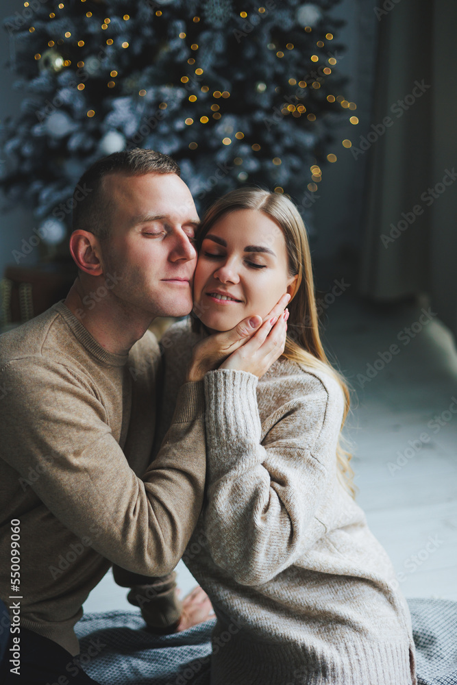 A couple in love enjoying each other on New Year's Eve. New Year's love story. A boy and a girl celebrate Christmas.