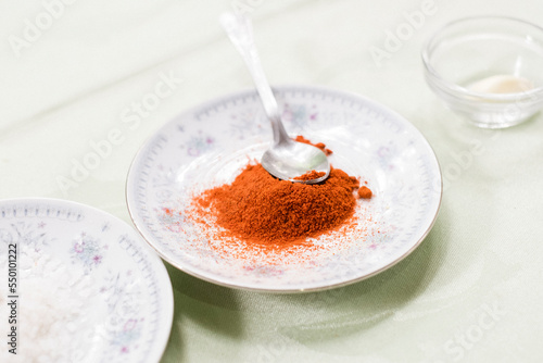 Sweet paprika on a plate, preparation of canadian mojo photo