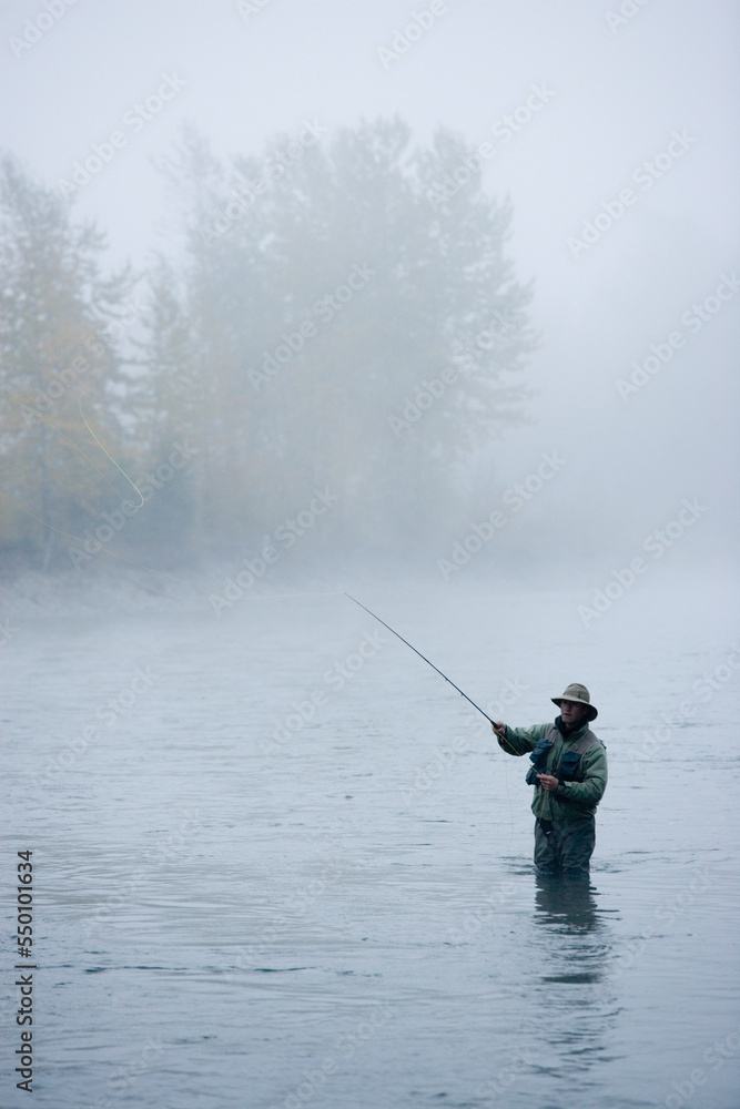 A man fly-fishing on Elk River, BC, Canada. A man fly-fishing on Elk River, BC, Canada.