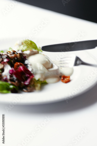 salad with herbs, mushrooms and poached egg photo