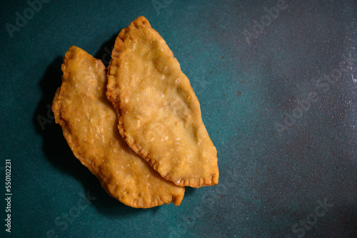 Caucasian cuisine. Uzbek Eastern Tatar cuisine, cheburek with meat and greens. Fried pie with meat and onions. Traditional Turkish and Mongolian dish.