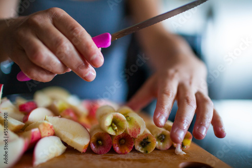 Hands of person cutting apples photo