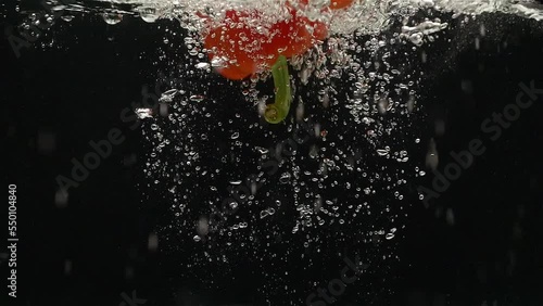 
pepper falls into the water in slow motion
