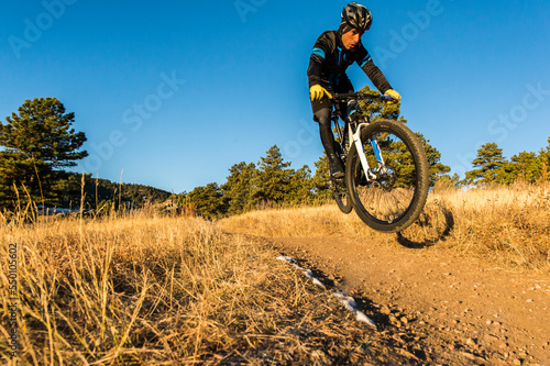 Wallpaper Mural Mountain biker mid-air while riding on dirt road, Golden, Colorado, USA Torontodigital.ca