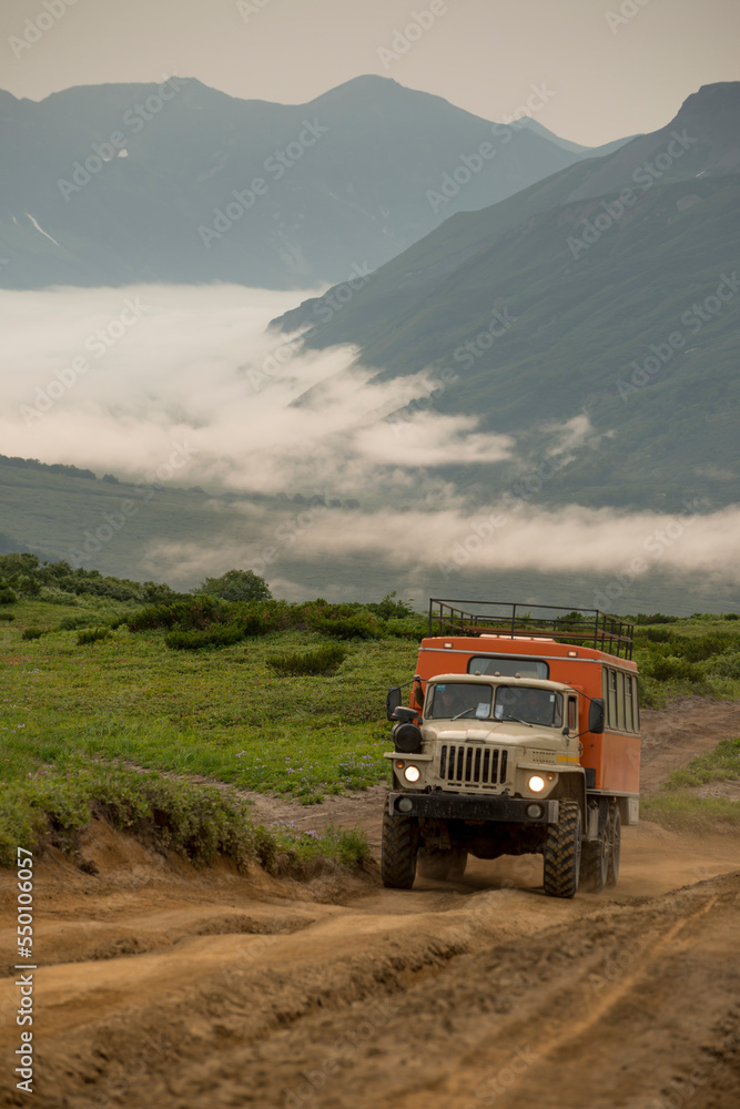 Large six wheel drive truck on a small road.  Kamchatka, Russia