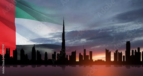 Canvas Print United Arab Emirates flag and Dubai skyline view at sunset