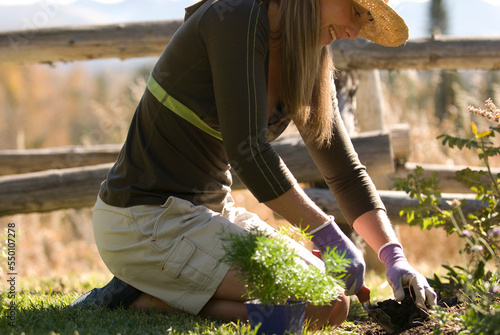 A young woman smiles while gardening in Jackson Hole, Wyoming.