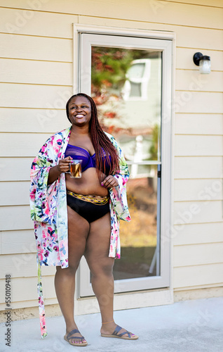 Black woman outside having tea with robe panty and bra on photo