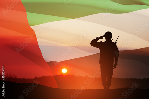 Foto Silhouette of soldier saluting on background of UAE flag and the sunset or the sunrise