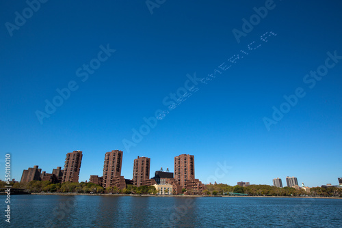 Patriotic skywriting over waterfront city skyline, New York City, New York, USA photo