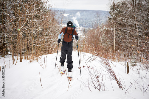 Man skinning his way through Vermont backcountry on splitboard photo