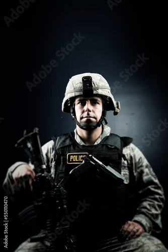 A Caucasian, male, Air Force Security Forces Airman in uniform poses with his M-4 rifle. photo