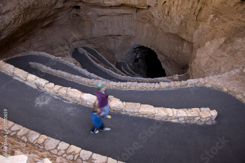 A mother and her son walking into Carlsbad Caverns from the natural entrance. photo