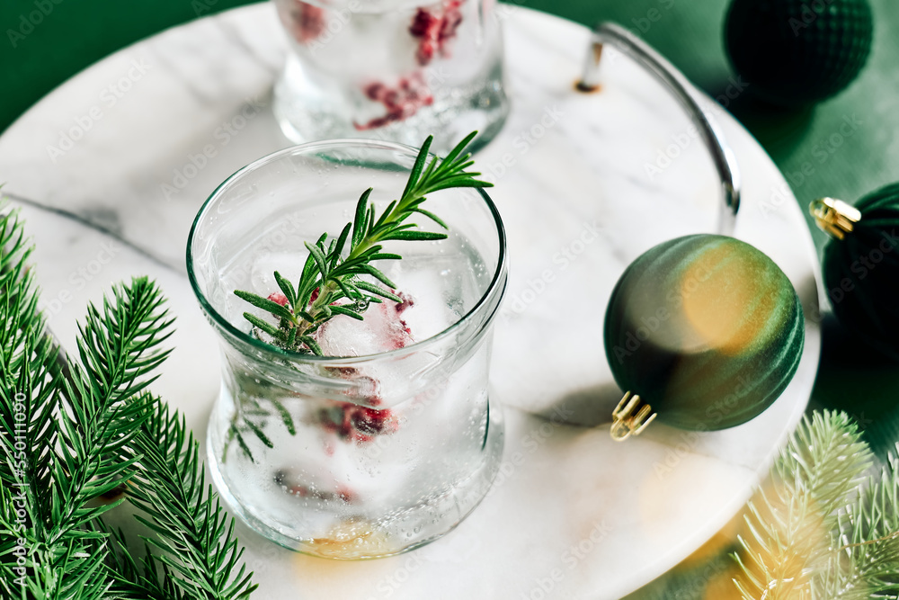 Christmas champagne cocktail with pomegranate ice cubes. Festive pomegranate mocktail. Delicious icy drink for christmas holiday. Christmas champagne cocktail with pomegranate ice cubes. Festive pomegranate mocktail. Delicious icy drink for christmas holiday.