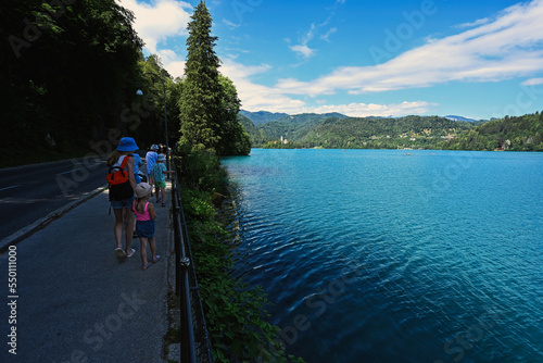 Family walking at embankment of beautiful Bled lake, Slovenia. © AS Photo Family