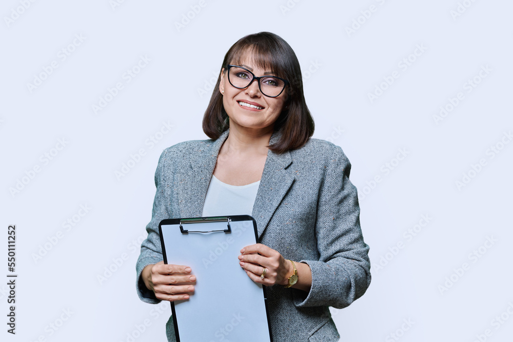 Business woman with clipboard on white studio background