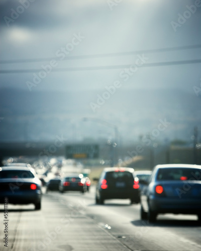 Defocused rear view of automobile traffic on a interstate highway in California, USA.