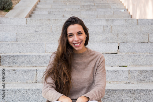 Portrait smiling woman sitting on stairs in Boadilla del Monte photo