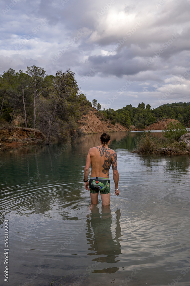 Men fishing near a lake in underwear Men fishing near a lake in underwear