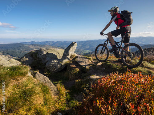 Mountain biker cycling on single trail on Ringelbuhlkopf, Alsace, France