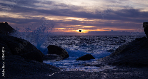 Marine scenic sunset with solar eclipse in the distance.