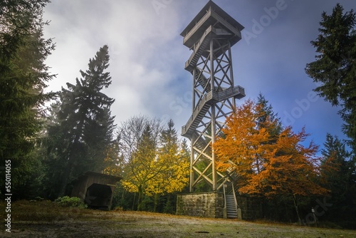 Low angle of the Upper Palatinate observational tower around autumn trees in Steinwald, Germany photo