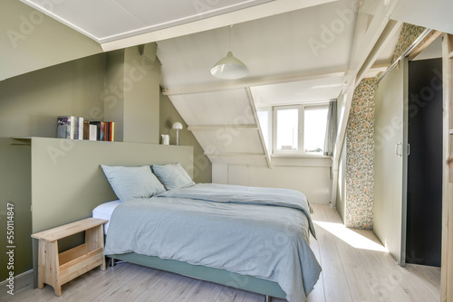 Photos Comfortable bed placed near wall in modern minimalist style mansard bedroom with