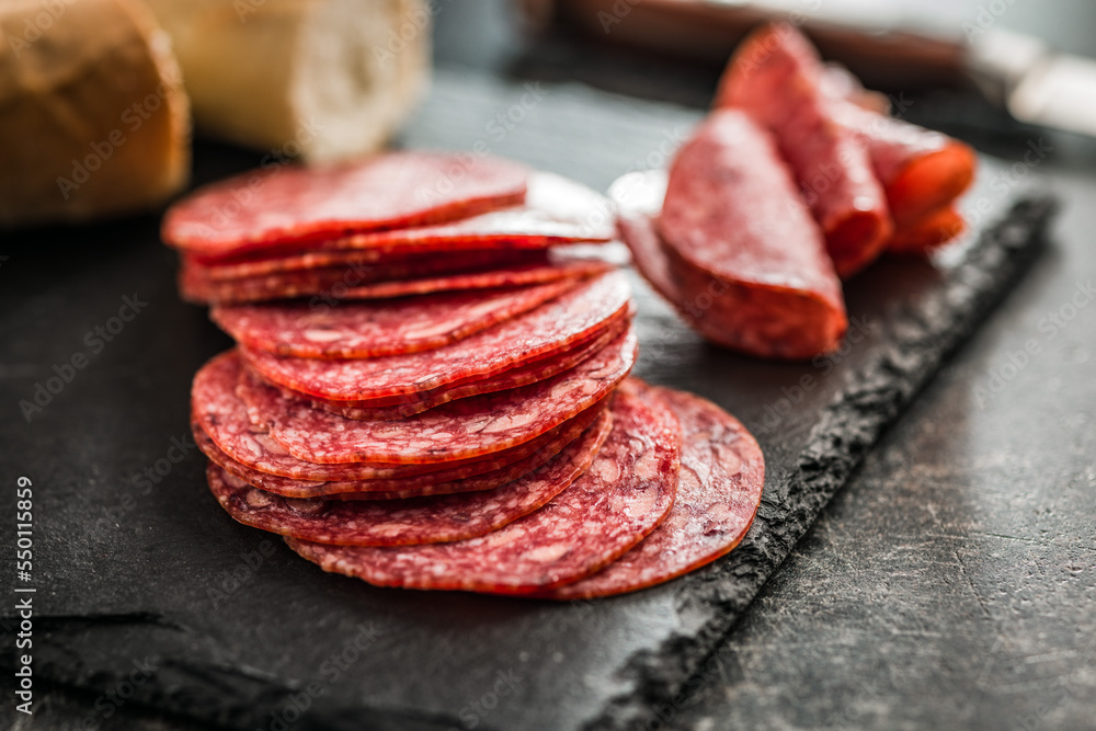 Sliced mexican salami with beans on cutting board. Sliced mexican salami with beans on cutting board.