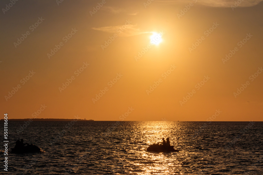 Silhouette of personal watercrafts in the Indian ocean at sunset in Zanzibar, Tanzania
