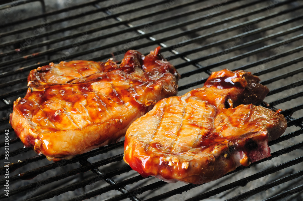 BBQ pork chops on a charcoal grill BBQ pork chops on a charcoal grill
