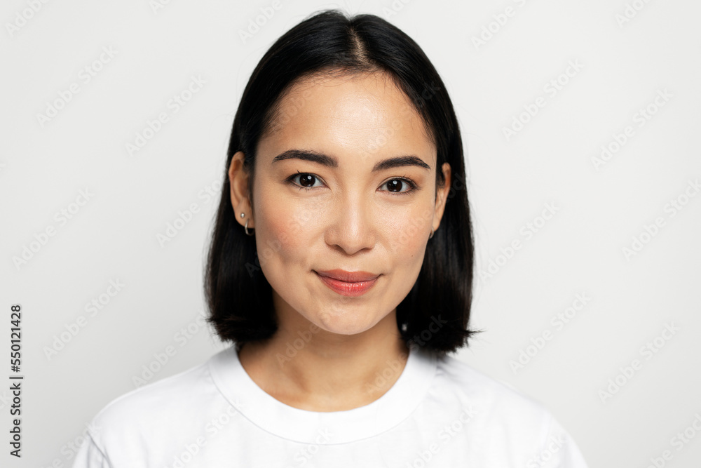Portrait of happy successful asian woman standing, looking at camera with charming smile
