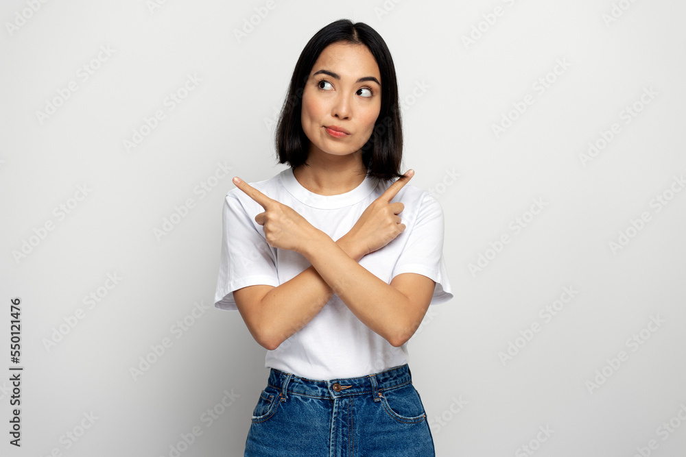 Serious confident bossy woman pointing fingers, making choice, thinking Serious confident bossy woman pointing fingers, making choice, thinking
