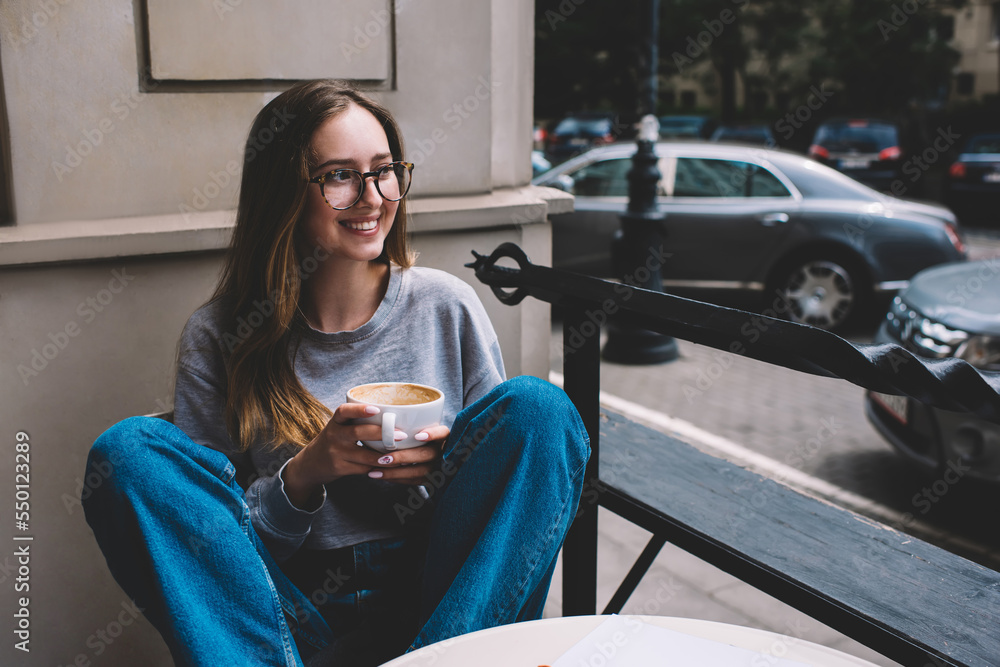 Delighted woman with cup of coffee