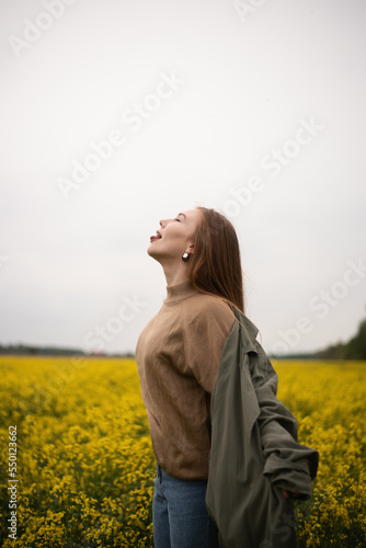 Cheerful girl in the field in summer