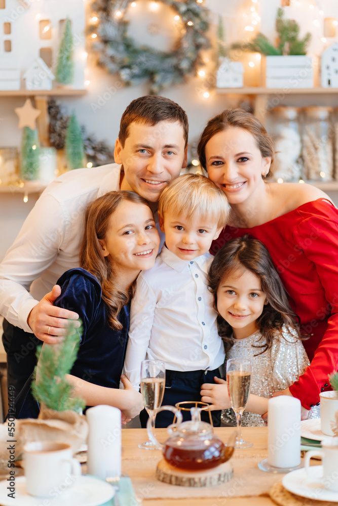Beautiful big family in the kitchen with Christmas decor. to cook together. Beautiful big family in the kitchen with Christmas decor. to cook together.