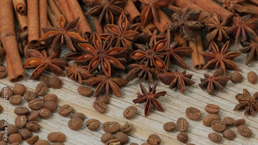Background with cinnamon sticks and anise stars rotate. Close-up of various spices rotating on wooden table top view slow motion Background with cinnamon sticks and anise stars rotate. Close-up of various spices rotating on wooden table top view slow motion