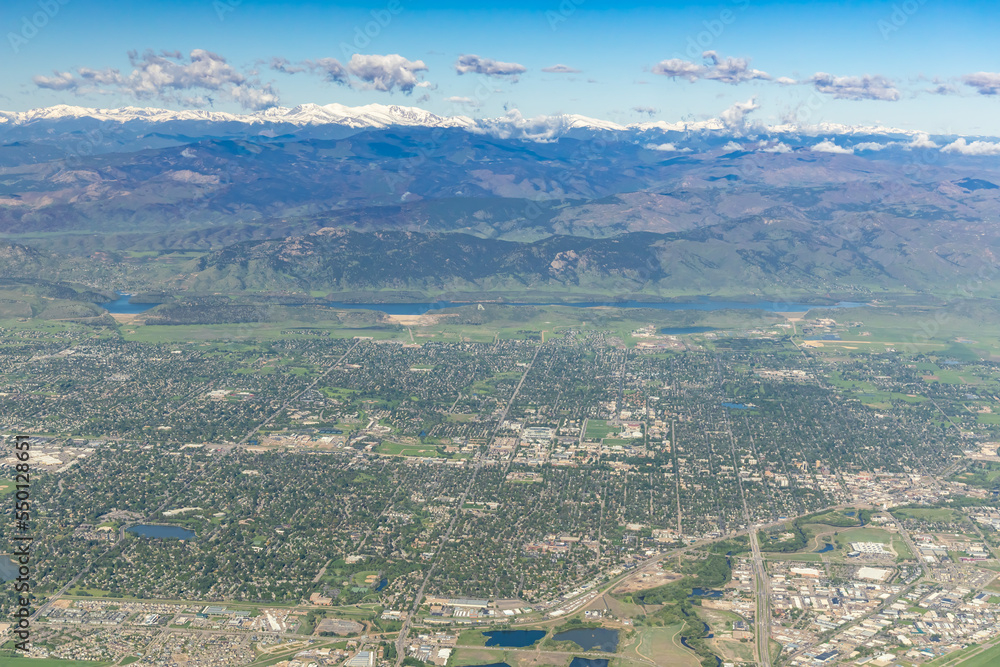 Aerial View of Ft. Collins, Colorado with Snow Capped Rocky Mountains in background.